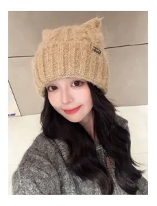 Detail shot of women's cute cat ear knit beanie hat, winter warm pullover cap in khaki.