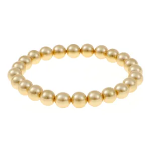 Golden round beaded elastic bracelet detail shot, elegant daily wear accessory for women.