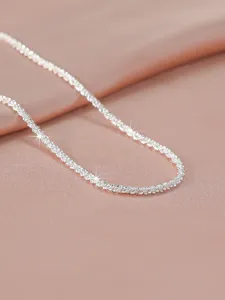 Exquisite sparkling silver collarbone necklace, minimalist style for women detail shot.