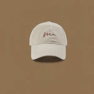 Beige baseball cap for women and men, classic curved brim with red me embroidery design.