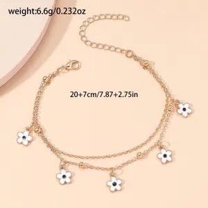 Gold double layer anklet with white enamel flower charms and black centers, 20+7cm length.