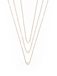 Detailed view of a trendy multi-layered gold chain necklace with faceted heart pendants.