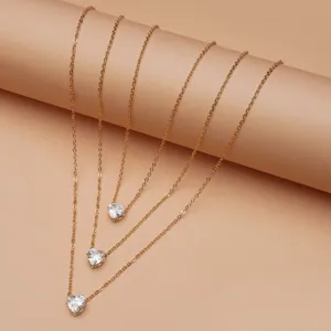 Minimalist multi-layer gold chain necklace with sparkling heart zircon pendants for women.