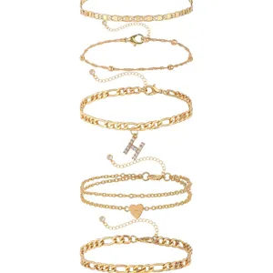 Gold anklet set featuring letter H pendant, exquisite chain layers and heart charm for women.