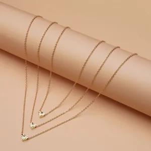 Minimalist gold layered heart pendant necklace for women, stylish multi-strand jewelry piece.