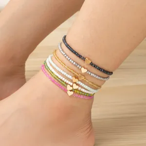 Cavigliera bohémien in perline di vetro colorate con ciondolo a cuore dorato per donna estate
