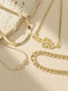 Chic multi-layer gold chain necklace set featuring sparkling rhinestone snake pendant.