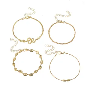 Fashion gold anklet set featuring four unique styles including a rhinestone snake pendant chain.