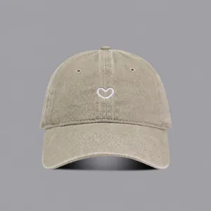 Washed cotton baseball cap with cute heart embroidery, vintage distressed style for outdoor wear.