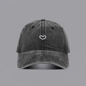 Vintage washed baseball cap with cute white heart embroidery, casual adjustable sun hat.