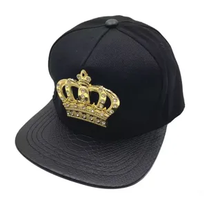 Black hip-hop baseball cap with gold rhinestone crown badge and PU leather flat brim.