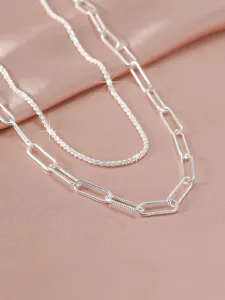 Detailed close-up of double-layer silver paperclip chain necklace with sparkling textured details.