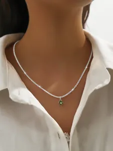 Delicate silver chain necklace featuring a stunning green stone pendant for chic style.