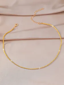 Delicate gold sparkle chain detail shot, minimalist clavicle necklace, elegant jewelry design.