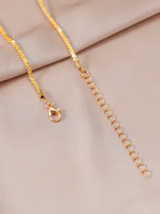 Exquisite gold shimmering chain necklace detail, delicate sparkling design accessory.