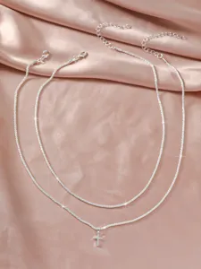 Layered silver chain necklace with cross pendant, sparkling choker jewelry for women.