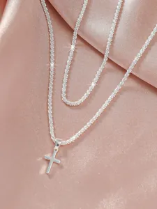 Close-up detail of the silver shimmer cross pendant necklace showcasing fine chain sparkle.