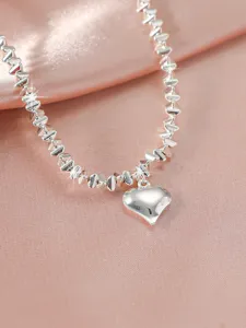 Detailed view of the sparkling silver heart pendant necklace with delicate beaded chain design.