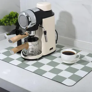 Green and white checkered diatomaceous earth kitchen drain mat, absorbent quick-dry pad.