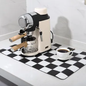Detail view of black and white checkered coffee mat on counter, absorbent and safe.