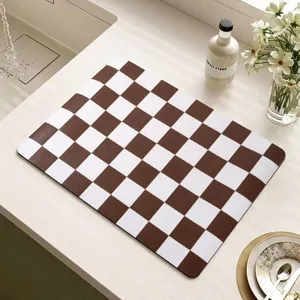 Brown and white checkered diatomaceous earth drying mat detail shot for kitchen coffee bar.