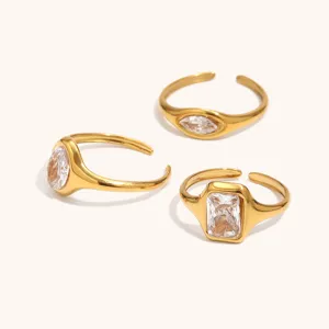 Detailed view of 18K gold plated stainless steel rings featuring marquise, oval and square zircon stones.