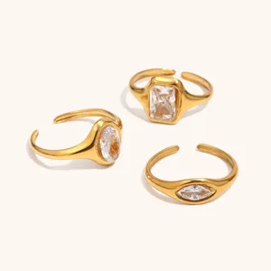 Detailed shot of three minimalist 18k gold plated stainless steel geometric zircon rings.