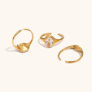 Detail view of 18k gold plated stainless steel open rings with zircon and geometric shapes.
