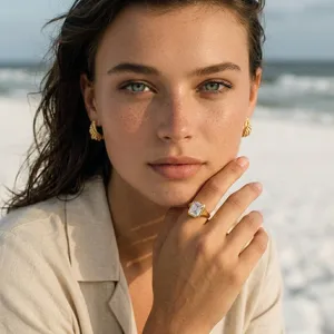 Close-up detail shot of a luxury gold plated ring featuring a sparkling emerald cut zircon stone.