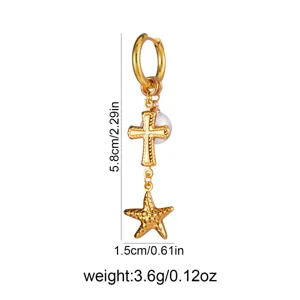 Detail shot of the vintage gold-tone drop earring featuring a textured cross and starfish.