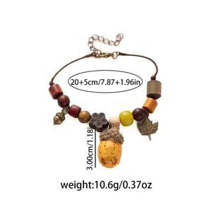 Vintage wooden bead bracelet detail showing acorn pendant and maple leaf charm craftsmanship.