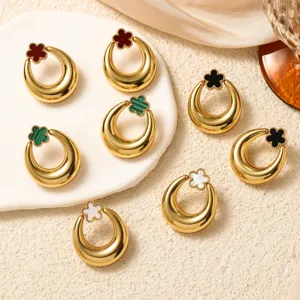 Detailed view of vintage gold metal crescent earrings featuring colorful clover inlay.