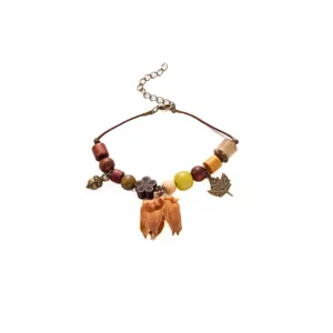Handmade retro ethnic wooden bracelet featuring natural botanical charms and extension chain.