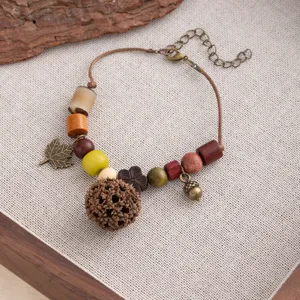 Handmade vintage ethnic style wooden bead bracelet with acorn pendant for women artistic jewelry.