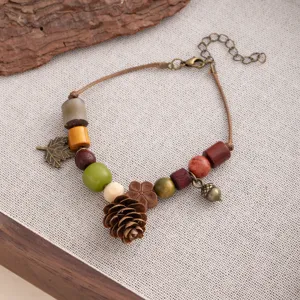 Vintage bohemian handmade wooden bead bracelet with cute pinecone and acorn charms for women.