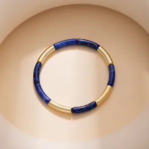 Close-up detail of a fashion leopard print and gold-tone metal geometric linked bracelet.