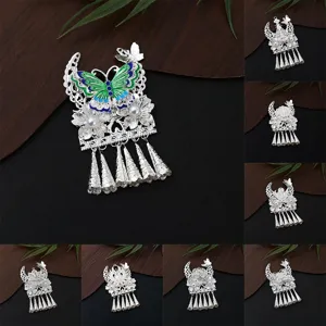 Detailed view of traditional Chinese Miao silver butterfly tassel DIY pendant and magnet.