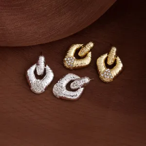 Detailed view of retro rhinestone textured diamond earrings displaying unique geometric shape.