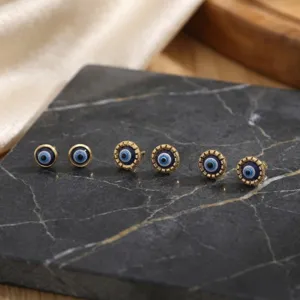 Evil eye gold-plated stud earrings set featuring chic blue enamel drip oil design for women.