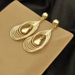 Gold metal geometric hollow layered teardrop dangle earring detail shot, stylish and unique.