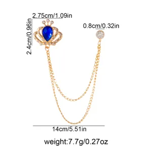 Gold crown brooch with blue teardrop crystal and tassel chains, elegant fashion jewelry item.