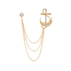 Gold anchor brooch with sparkling rhinestones and multi-strand chain tassel, elegant jewelry.