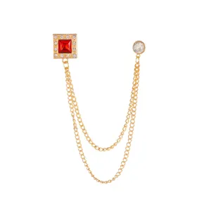 Exquisite gold-tone double chain brooch featuring a square red crystal and sparkling rhinestones.