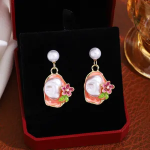 French vintage Monet garden earrings with baroque pearl, enamel flower and elegant gold trim.