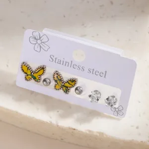 Detailed shot of stainless steel butterfly and rhinestone stud earrings set, minimalist design.