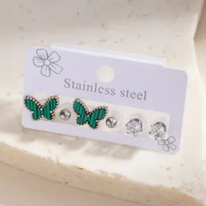 Stainless steel butterfly earring set featuring green malachite pattern and crystal studs.
