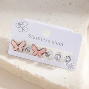 Detail shot of stainless steel stud earrings set featuring pink butterfly and crystal designs.