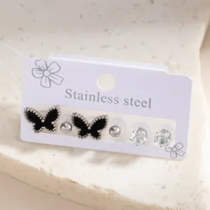 Stainless steel butterfly stud earrings set with crystal and black design details.