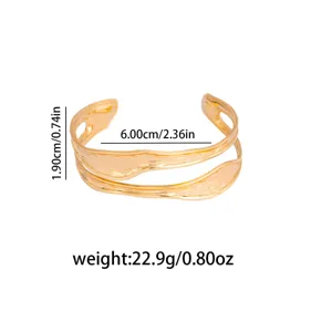 Close-up detail shot of the irregular hollow geometric open metal bangle showcasing product dimensions.