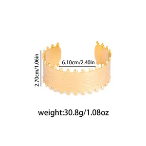 Gold open cuff bracelet with textured lines and beaded edge, detail view showing size.